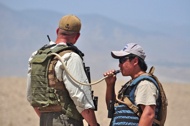 DSC_9696 - Version 2 An ABP trainer and his terp duringa rnage shoot. These trainers are from Xe which was Balckwater and is now something else I think. There are several dozen guys on the contract with some embeded American Army troops and they have a large base at the Pachir Wa Agam distrcit center. Using large regional training centers has proven to be a bust for train Afgahan police. These guys from Xe are first rate working a top of the line contract for excellent pay. They would be much more effective if they were out and about with their charges instead of being restricted to a training base.